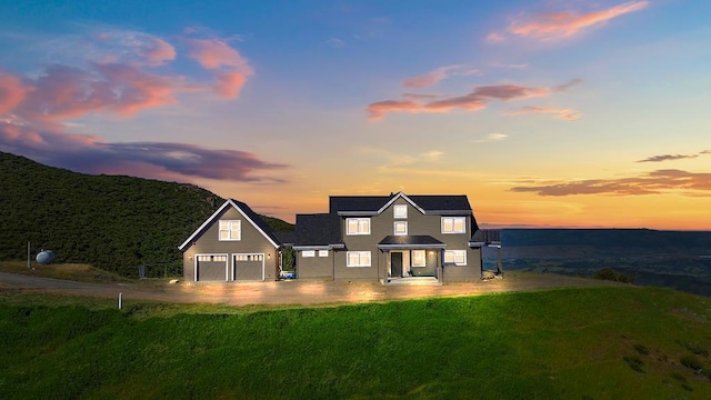 view of front of home with a lawn and a garage