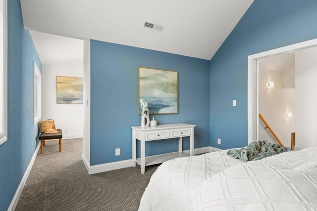 carpeted bedroom with lofted ceiling