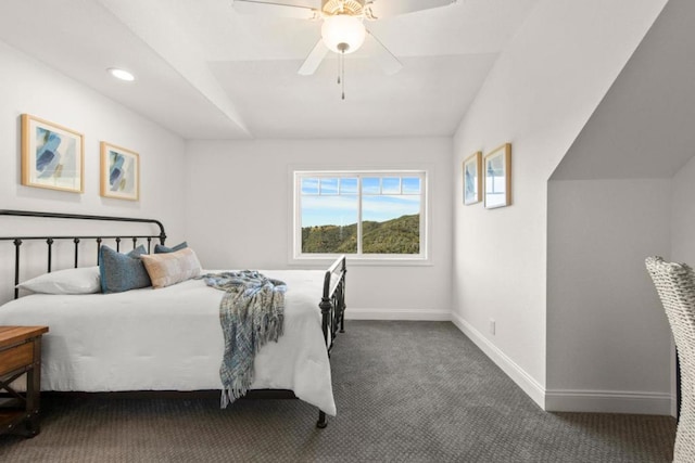 carpeted bedroom featuring vaulted ceiling and ceiling fan