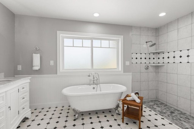 bathroom featuring separate shower and tub and vanity