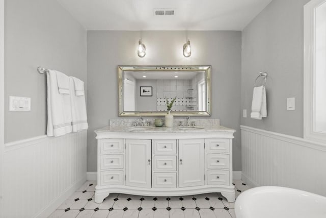 bathroom with a tub and vanity