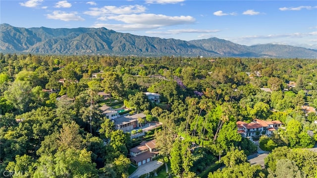 drone / aerial view with a mountain view and a wooded view