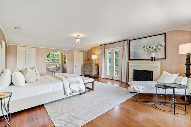 bedroom with hardwood / wood-style floors and vaulted ceiling