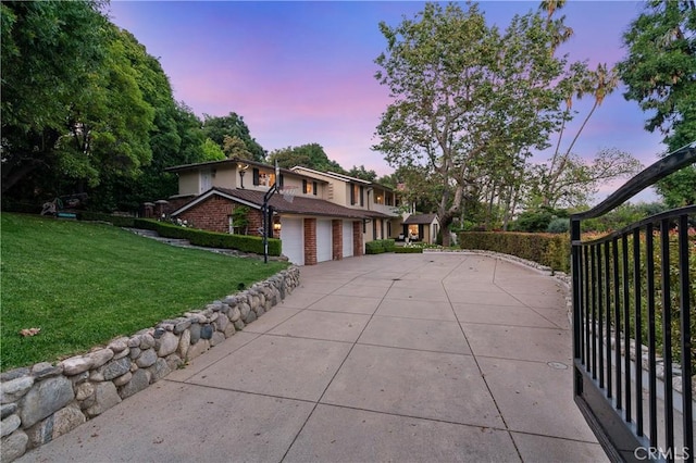 view of front facade with a lawn and a garage