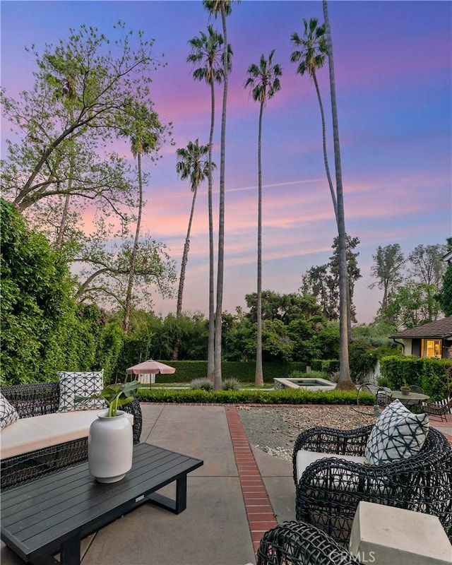 view of patio terrace at dusk