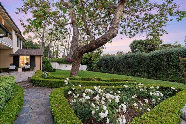 yard at dusk with a patio area