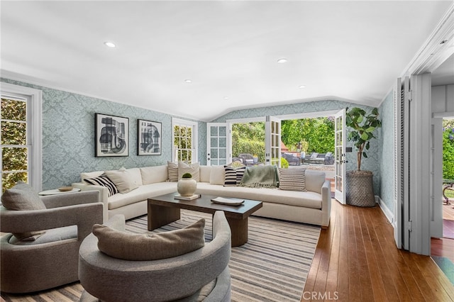 living room with vaulted ceiling and hardwood / wood-style flooring