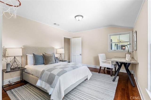 bedroom with wood-type flooring and vaulted ceiling