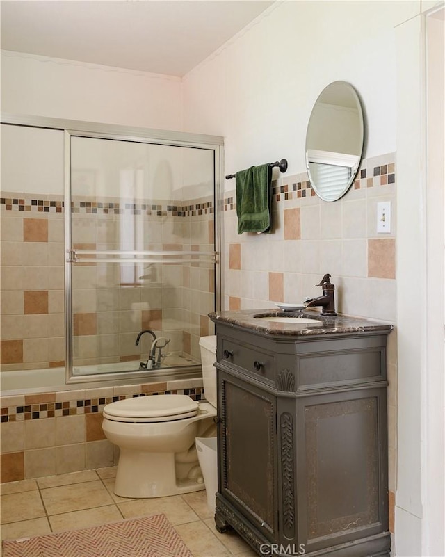 full bathroom featuring toilet, vanity, tile patterned floors, and separate shower and tub