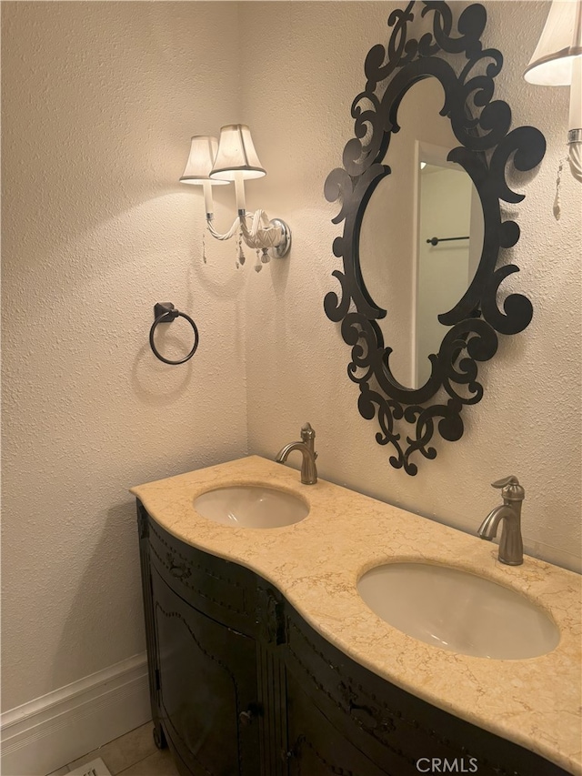 bathroom featuring tile patterned flooring and vanity