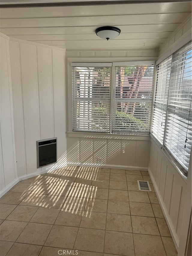 unfurnished sunroom featuring heating unit