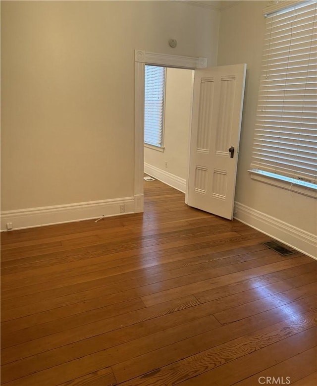 empty room featuring dark hardwood / wood-style flooring