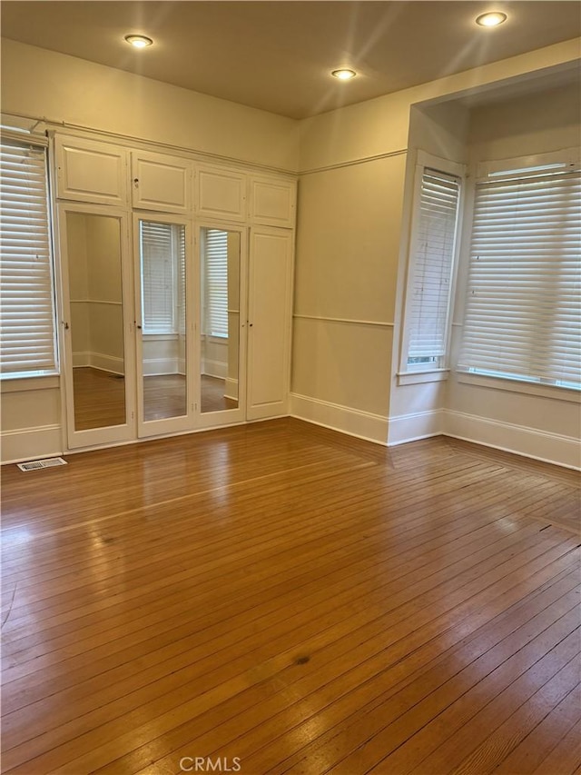 spare room featuring wood-type flooring