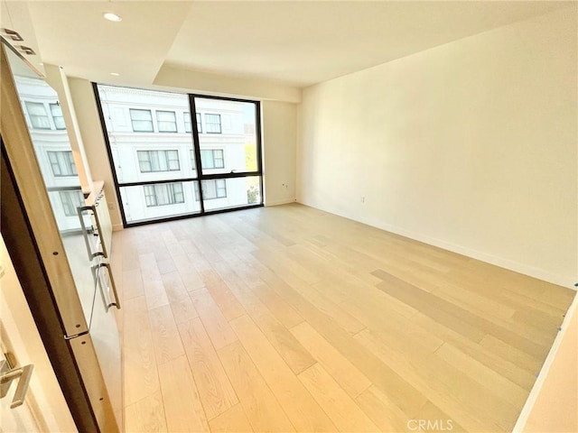 unfurnished room featuring light hardwood / wood-style floors