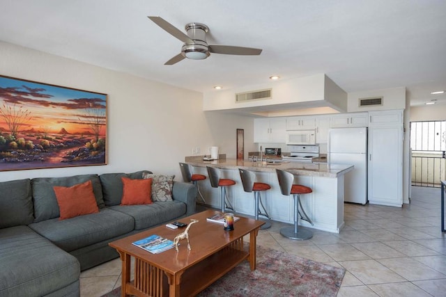 tiled living room featuring ceiling fan