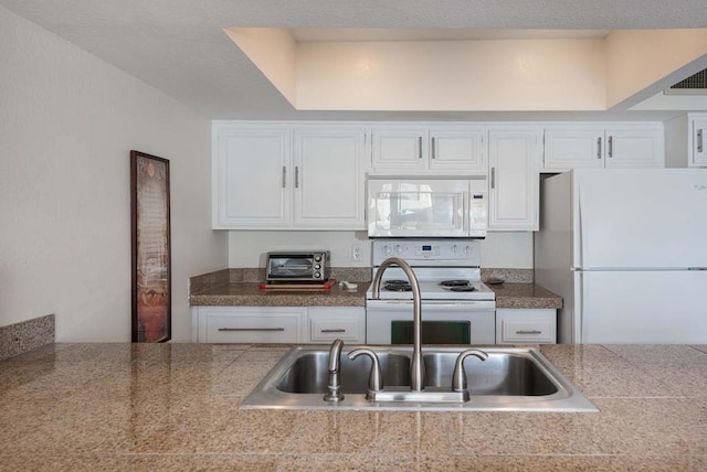 kitchen with white cabinets, white appliances, and sink