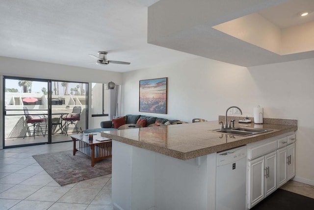 kitchen with white cabinets, white dishwasher, light tile floors, sink, and ceiling fan