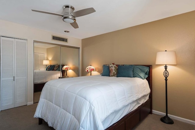 carpeted bedroom featuring multiple closets and ceiling fan