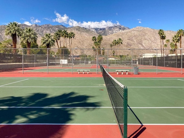 view of tennis court featuring a mountain view