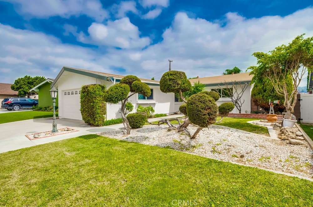 single story home featuring a front yard and a garage