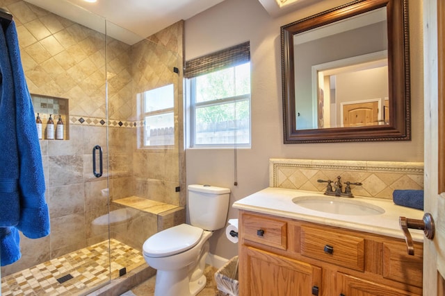 bathroom with tasteful backsplash, vanity, an enclosed shower, and toilet