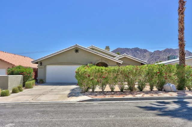 view of front facade with a mountain view and a garage