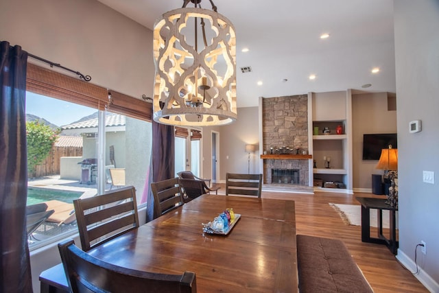 dining space with a fireplace and wood-type flooring