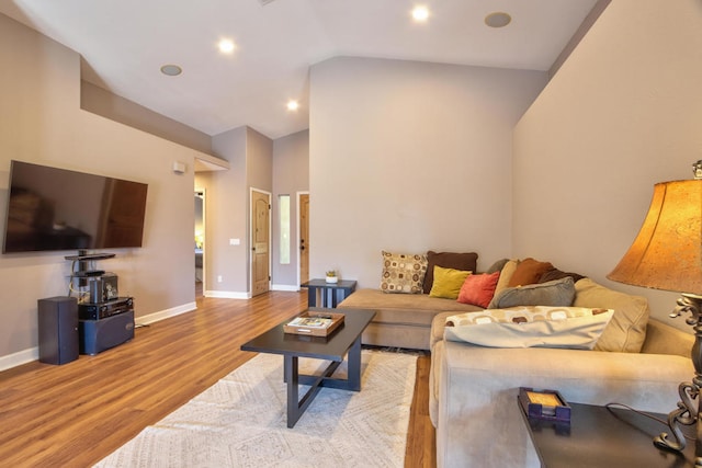 living room with hardwood / wood-style floors and vaulted ceiling