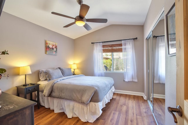 bedroom featuring hardwood / wood-style floors, ceiling fan, and vaulted ceiling