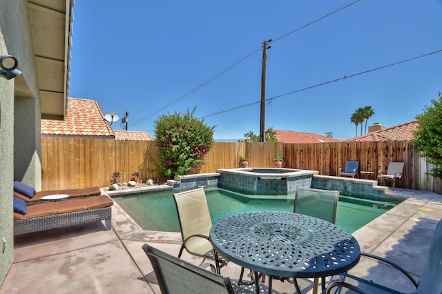 view of pool featuring an in ground hot tub