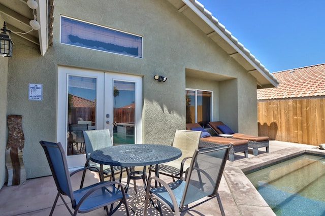 rear view of house with a patio area and french doors