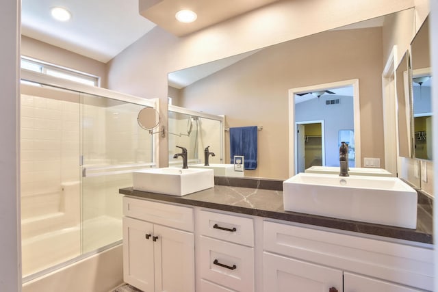 bathroom with vanity and bath / shower combo with glass door