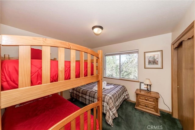 bedroom featuring dark colored carpet