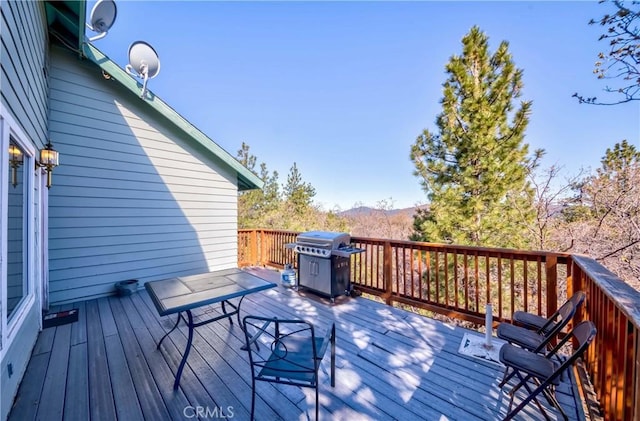 wooden deck with a grill