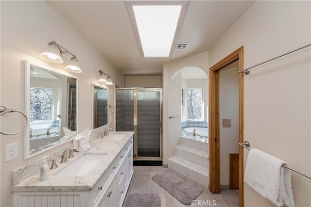 bathroom with tile patterned flooring, vanity, and independent shower and bath