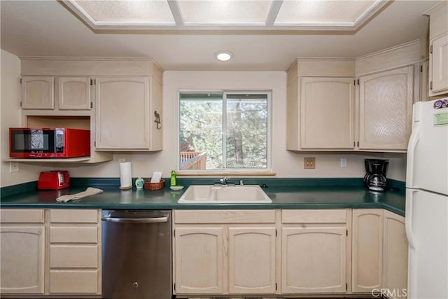 kitchen featuring sink, dishwasher, cream cabinetry, and white refrigerator