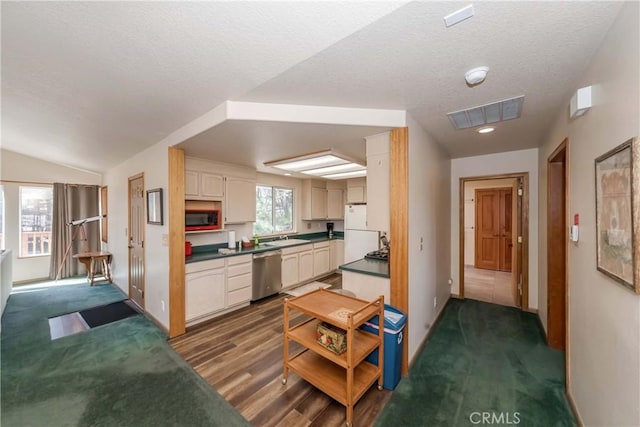 kitchen with dark hardwood / wood-style flooring, stainless steel dishwasher, black microwave, white refrigerator, and lofted ceiling