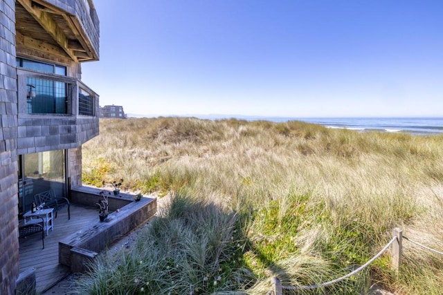 view of yard featuring a deck with water view