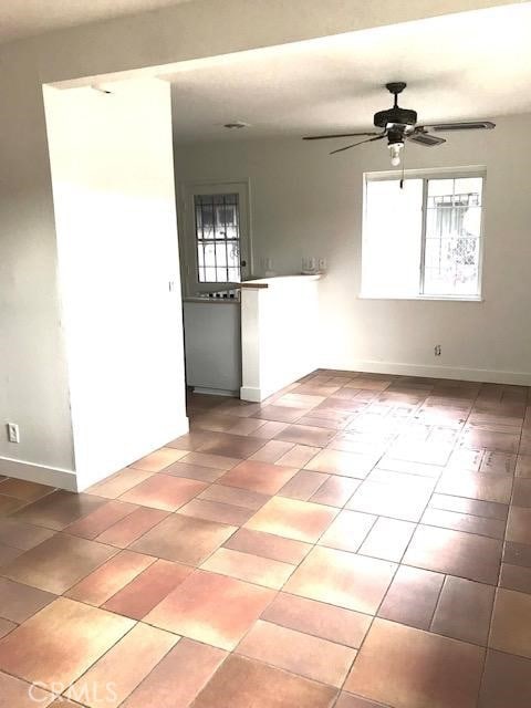 2529 S Rosewood Ave, Santa Ana, CA 92707 - empty room featuring light tile patterned flooring, ceiling fan, and baseboards