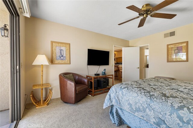 bedroom with ceiling fan and light carpet