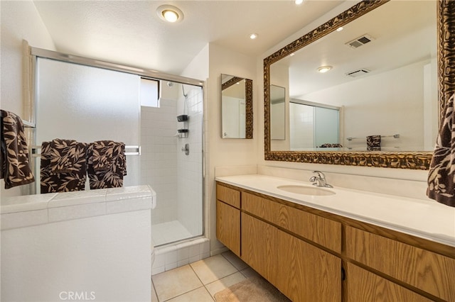 bathroom featuring tile patterned flooring, vanity, walk in shower, and a textured ceiling