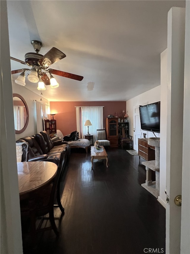 living room with ceiling fan and wood-type flooring