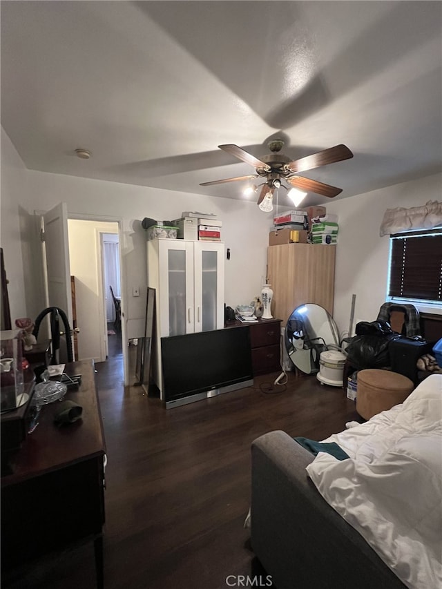 bedroom featuring ceiling fan and dark wood-type flooring