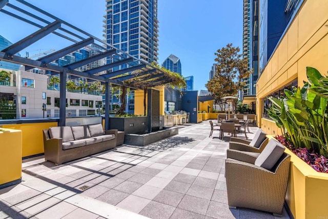 view of terrace with outdoor lounge area and a pergola