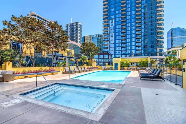 view of swimming pool featuring a hot tub