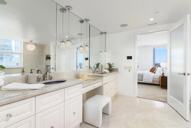 bathroom featuring a shower with door, large vanity, tile floors, and dual sinks