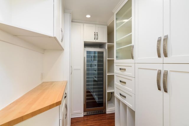 kitchen featuring wine cooler, dark hardwood / wood-style flooring, white cabinets, and butcher block counters