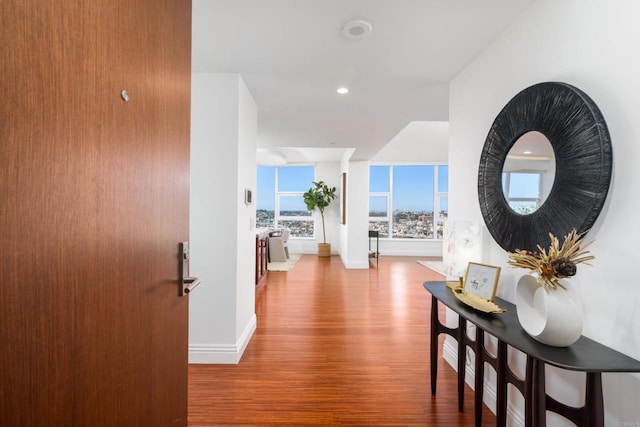 hallway with hardwood / wood-style flooring