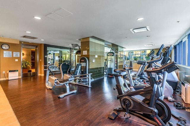 workout area featuring dark wood-type flooring