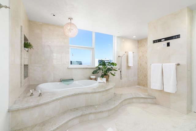 bathroom featuring shower with separate bathtub